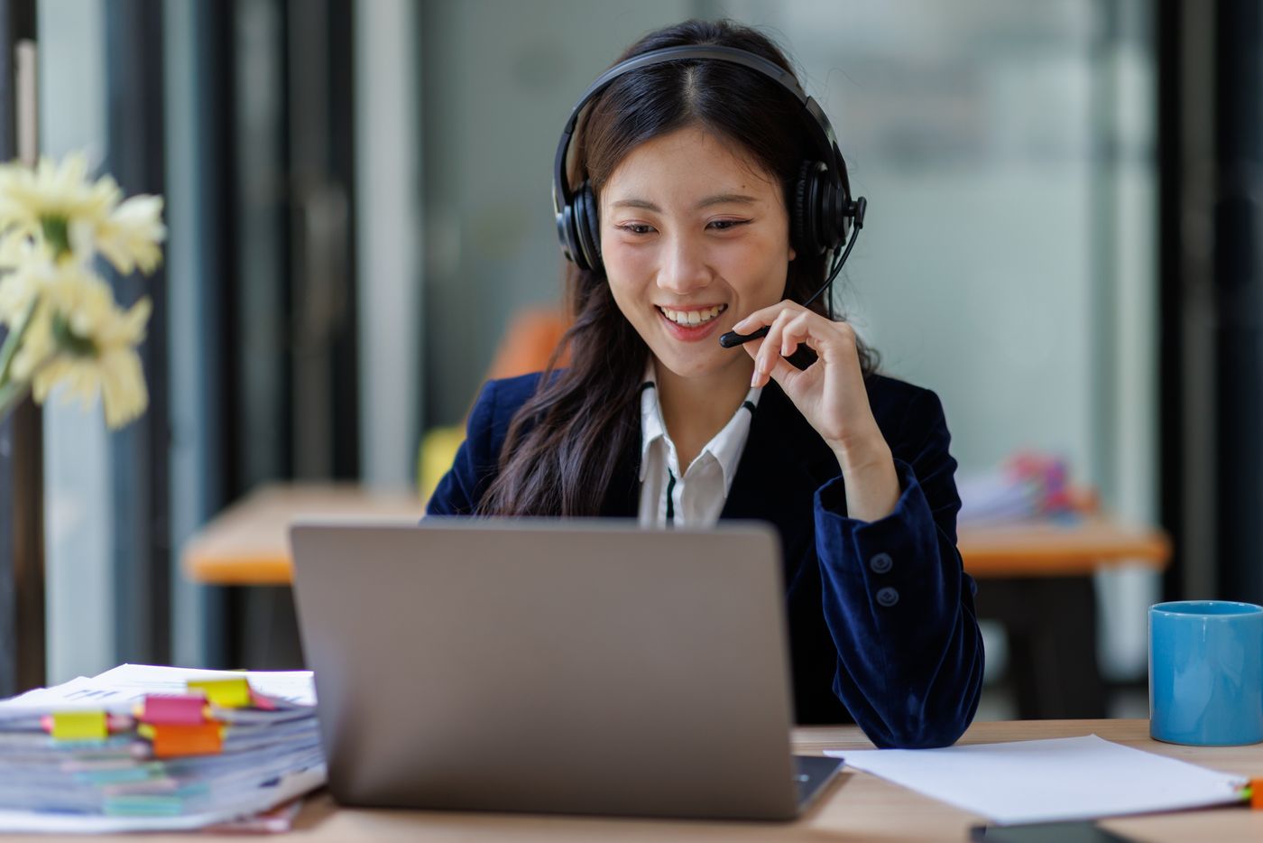 A team member taking a call on a headset in a modern office