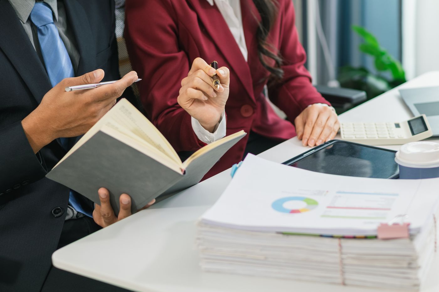 Two professionals reviewing compliance documents together
